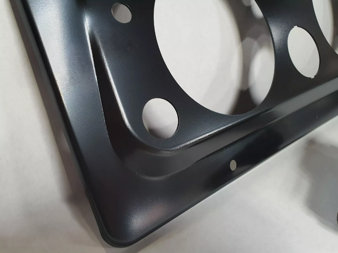 A Close up of the pressing on a Land Rover Petrol dash panel 1958-1966 in black primer.