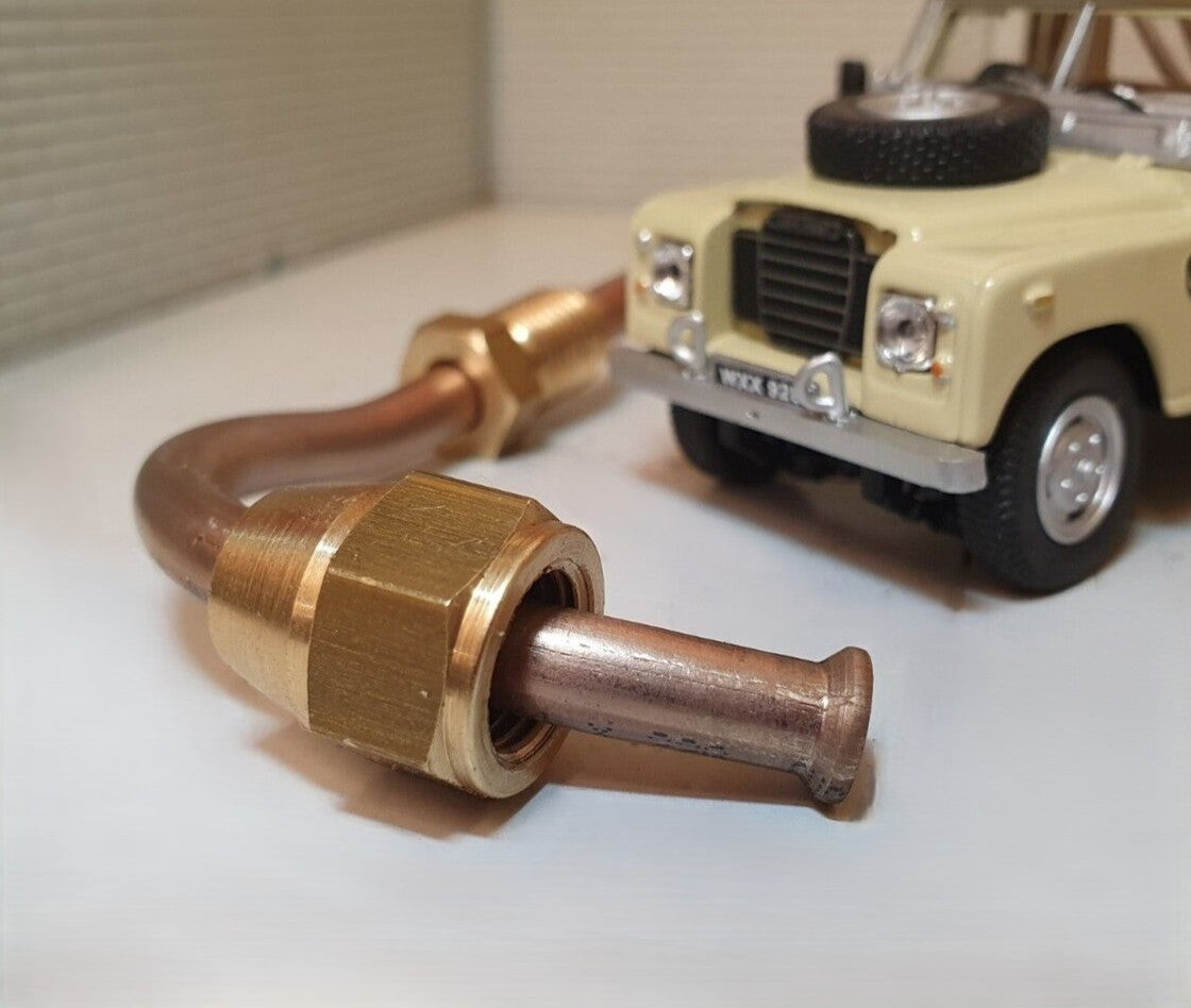 Close up of the brass fitting on a cupro nickel brake line.