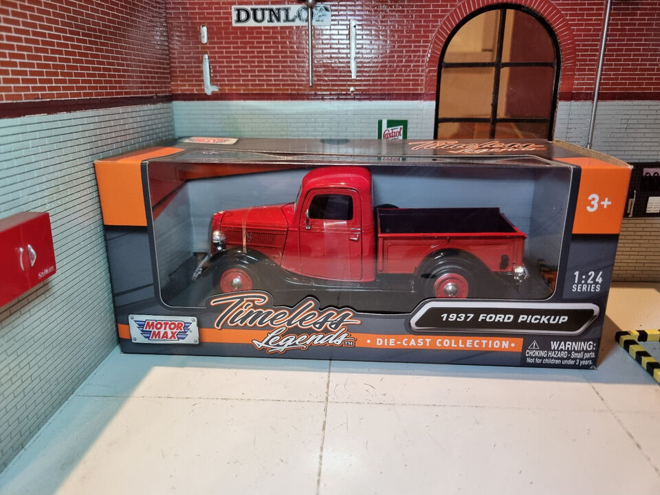 Boxed view of a model 1937 Ford pick up truck in red with black arches.