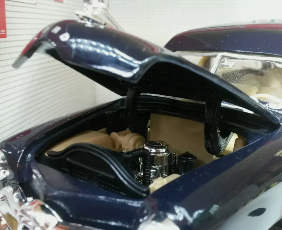 Close cup of the engine bay of a 1949 Ford Woody Station Wagon in black.