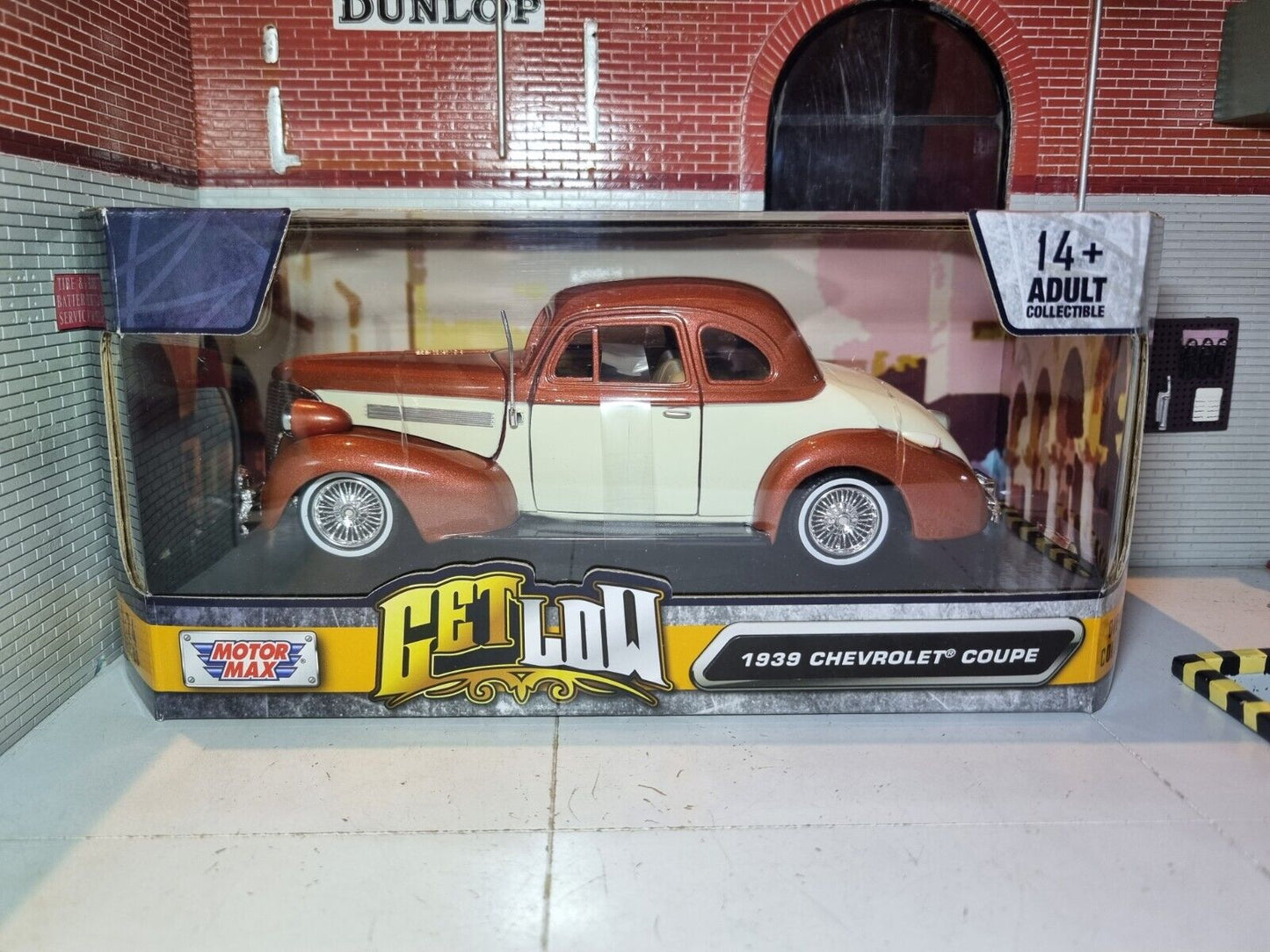 Boxed view of a Model of a modified 1939 Chevrolet coupe copper and cream. The Motormax logo can be seen along with the "Get Low" collection title and "1939 Chevrolet Coupe".