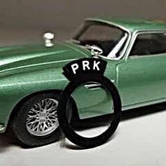 Aston Martin style switch tag reading "PRK".
