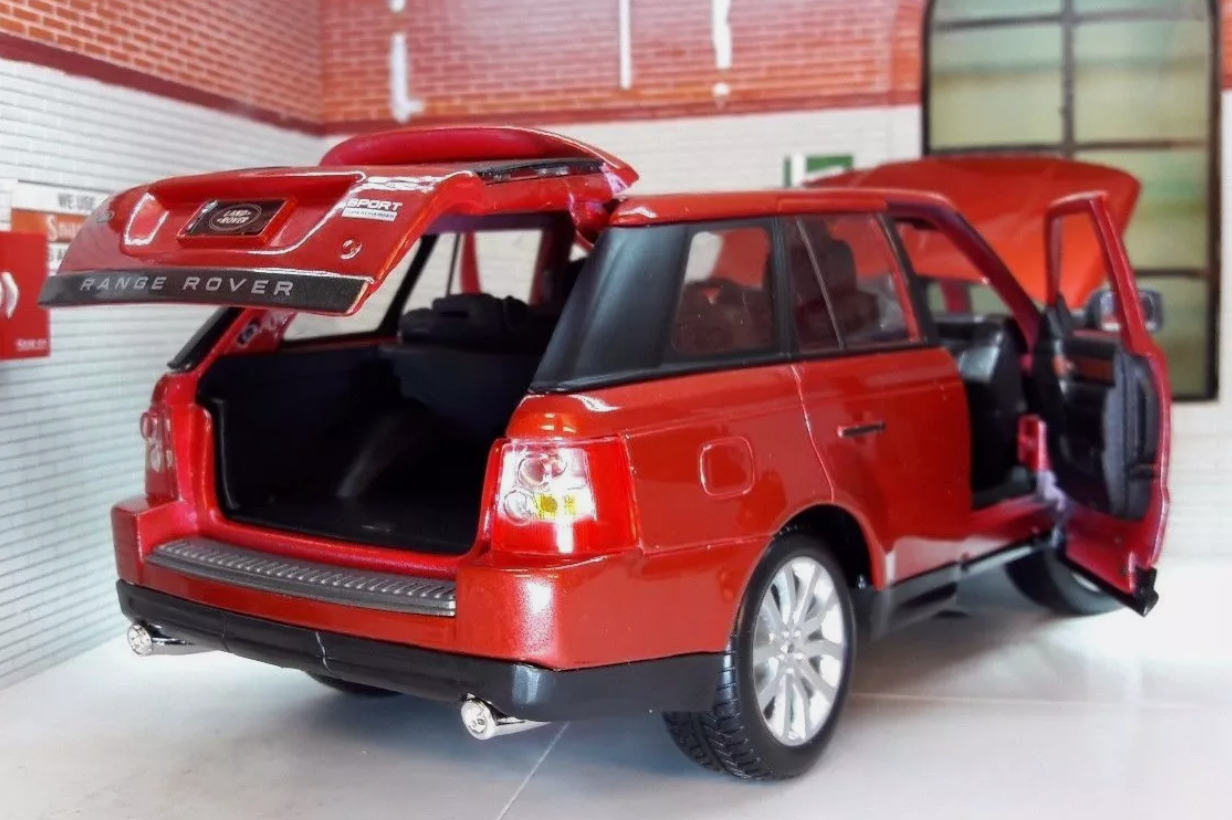 Rear quarter view of a model Range Rover Sport in Red. The bonnet, boot / trunk and front doors are open.