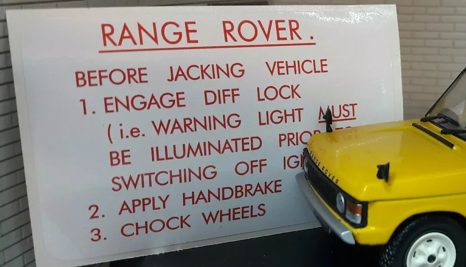 White decal with Red lettering detailing the jacking procedure of a Range Rover Classic.