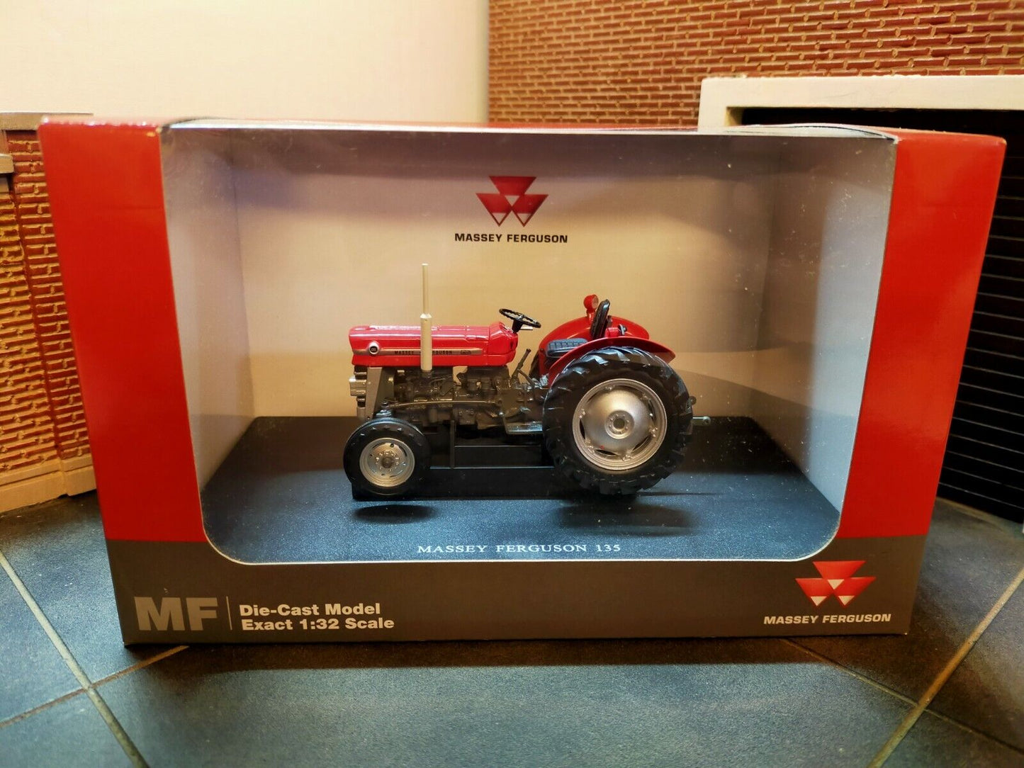 Boxed view of a model Massey Ferguson 135. The Massey Ferguson Logo is visible both inside and outside the box.
