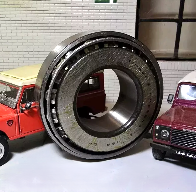 Land Rover Salisbury Axle Differential Pinion Bearing, on the left is a model of a Red Series 3 and one the right a Red Defender