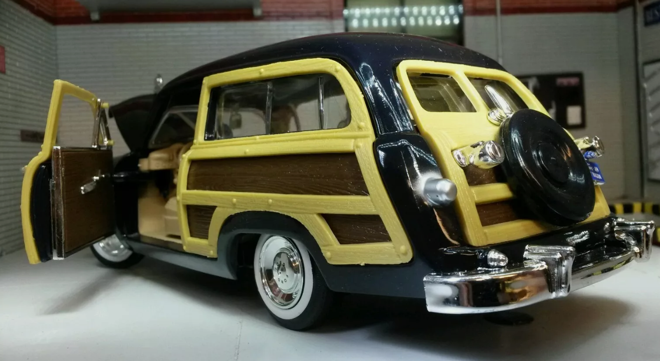 Rear quarter view of a 1949 Ford Woody Station Wagon in black.