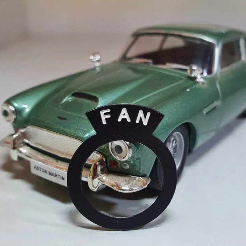 Aston Martin style switch tag reading "FAN".