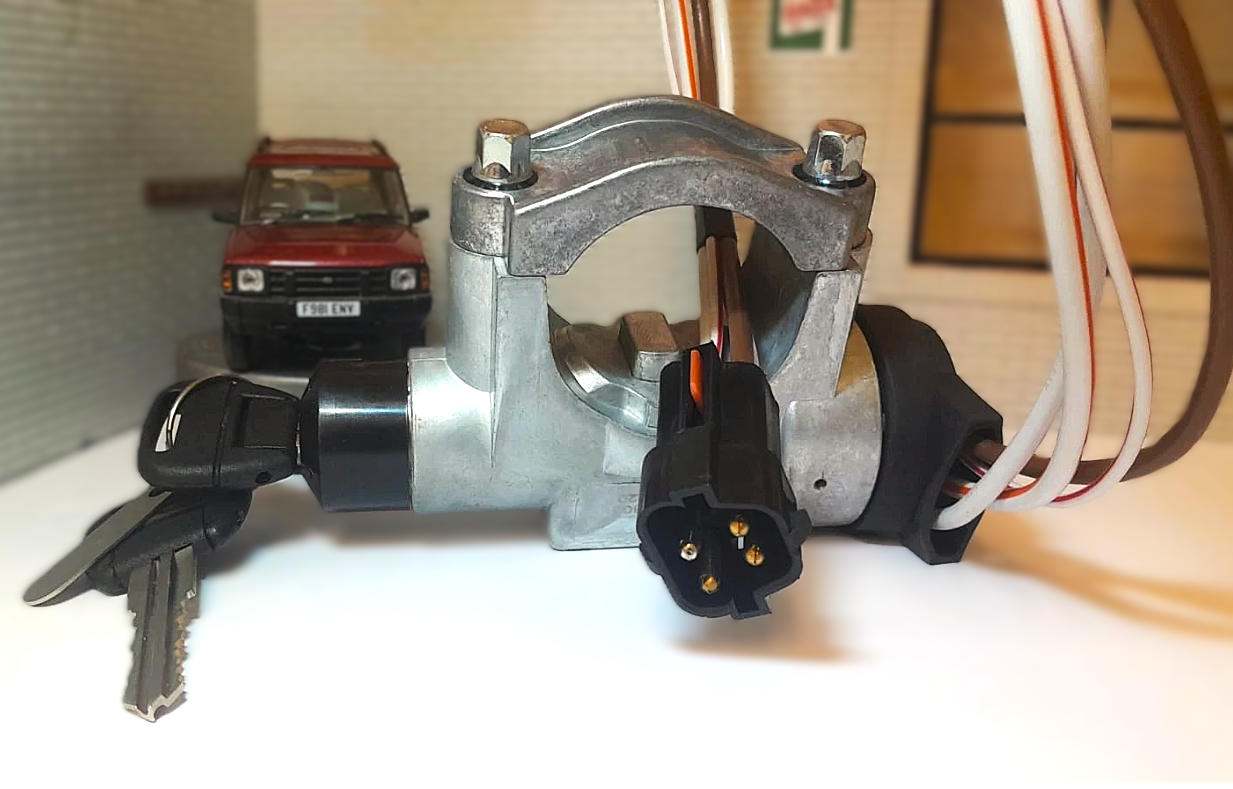 Car ignition switch with key and wiring on a white surface