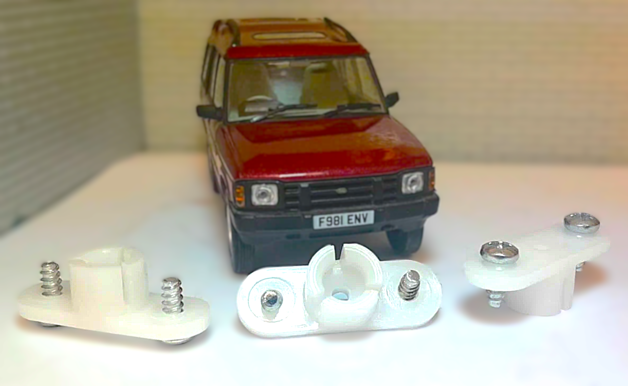 Model car with white mechanical parts on a white surface