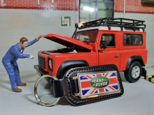 A Land Rover Key Ring. The Green oval logo sits on a Union Jack background which are attached to a leather fob.