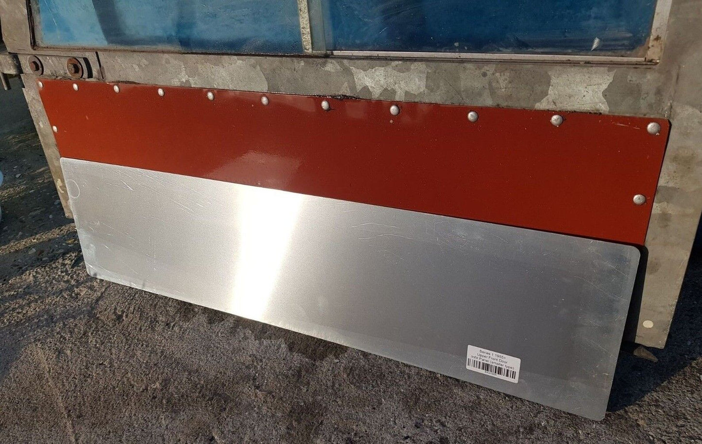 Aluminium Series 1 door top panel, leant against a door with a panel fitted for comparison.